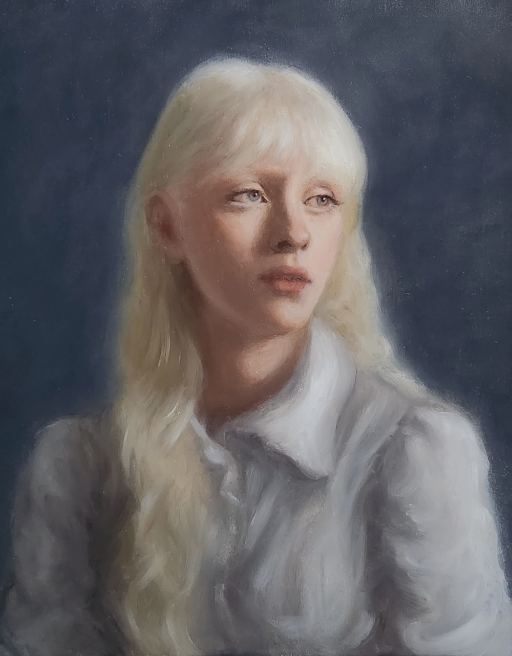 Portrait of a fair-haired woman in a light blouse
