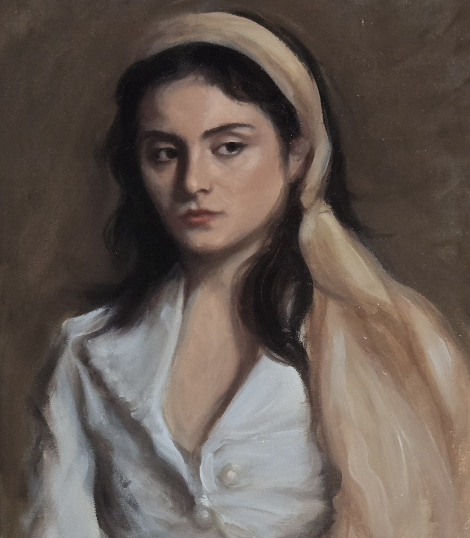 Portrait of a woman wearing a pale headscarf