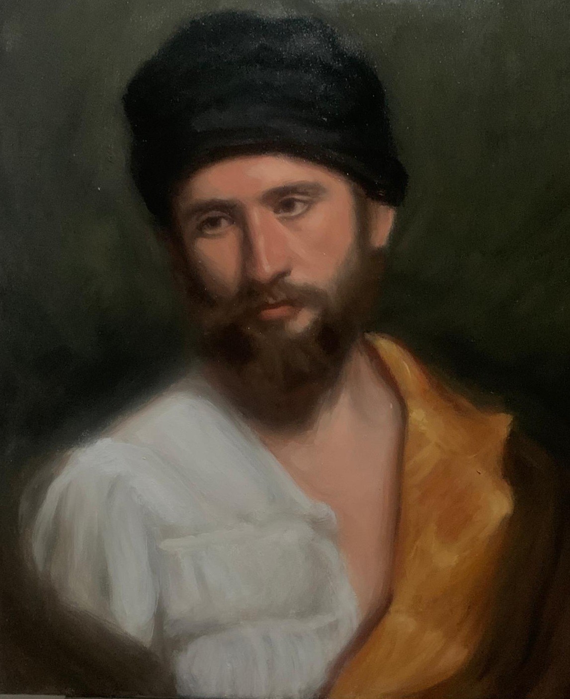 Portrait of a bearded man wearing a dark turban and ochre drape