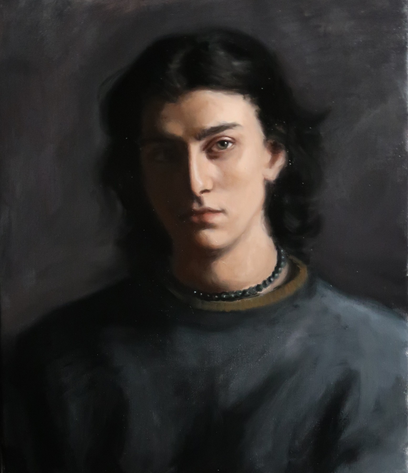 Portrait of a dark-haired man in a dark shirt
