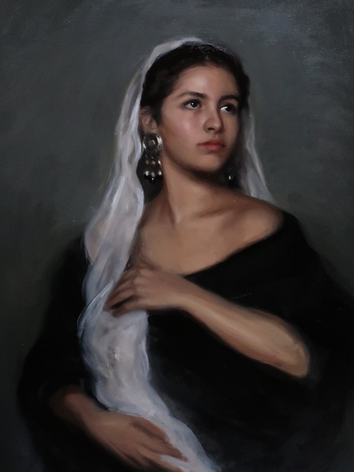 Portrait of a woman holding a white veil