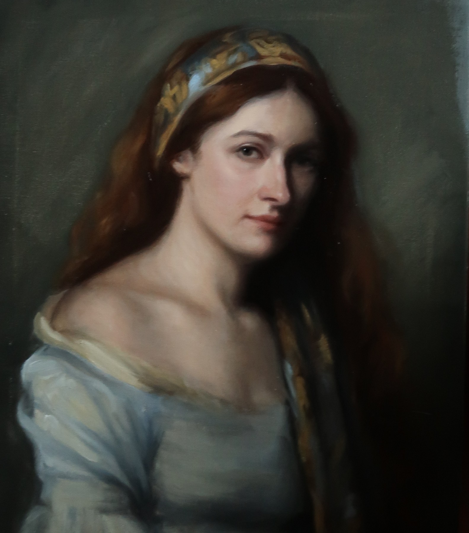 Portrait of a red-haired woman wearing a patterned headband