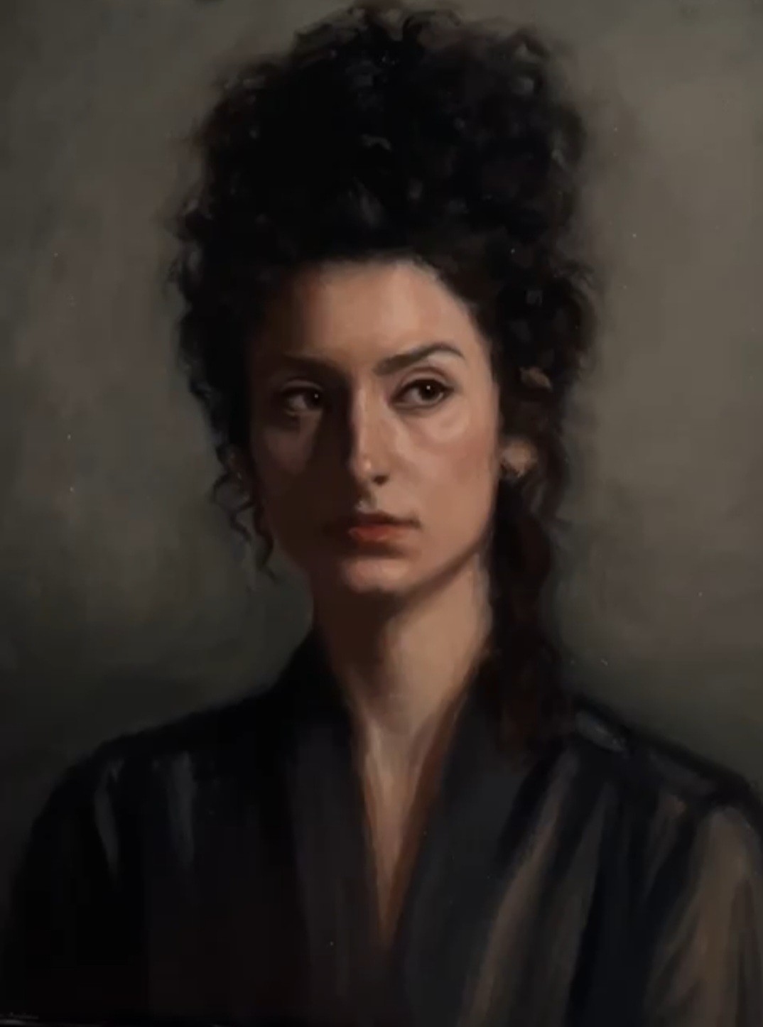 Portrait of a woman with her hair in a high bun