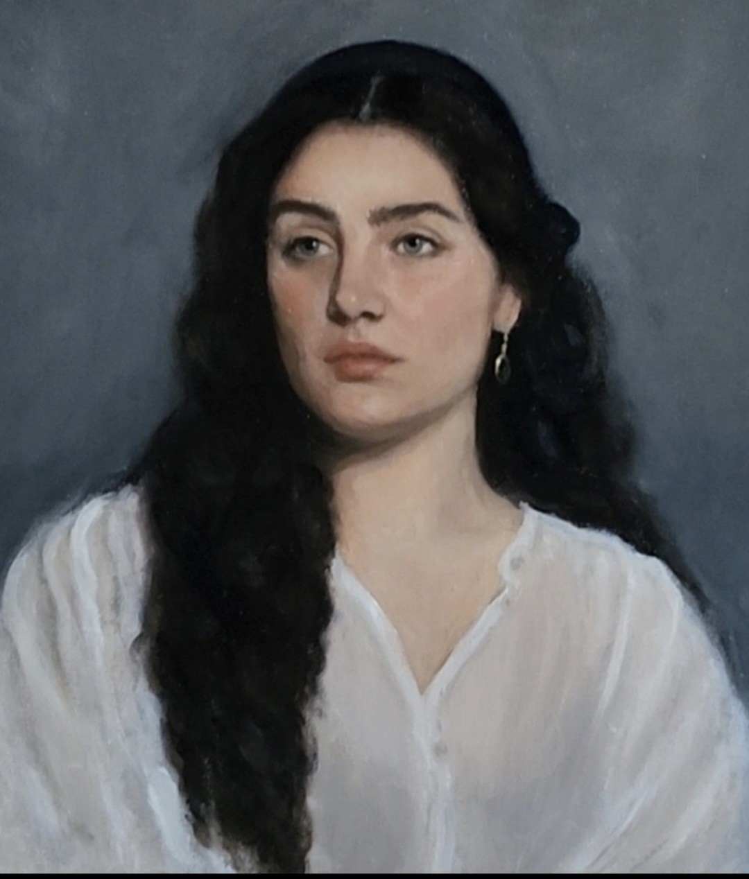 Portrait of a dark-haired woman in a white blouse