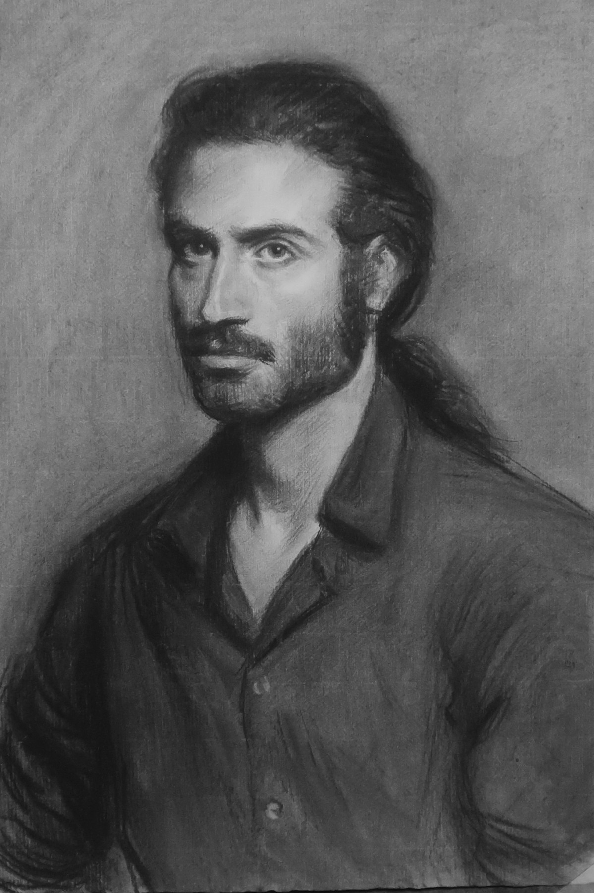 Charcoal portrait of a man in an open-collared shirt